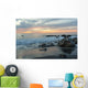 Water Washing Up On The Beach Around The Rocks At Sunset Wall Mural