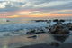 Water Washing Up On The Beach Around The Rocks At Sunset Wall Mural