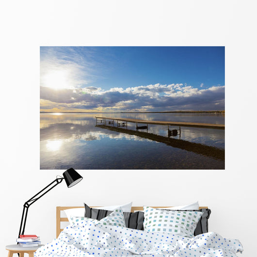 A Dock Leading Out Into The Lake At Sunrise Wall Mural