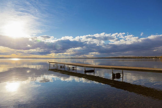 A Dock Leading Out Into The Lake At Sunrise Wall Mural