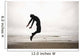 An Individual Wearing A Wet Suit Jumping In Mid-Air On A Beach Wall Mural