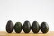 A Row Of Avocados Standing Upright On A Wooden Board Wall Mural