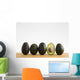 A Row Of Avocados Standing Upright On A Wooden Board With One Cut Wall Mural