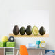 A Row Of Avocados Standing Upright On A Wooden Board With One Cut Wall Mural