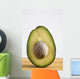 Close Up Of An Avocado Standing Upright Cut In Half With The Pit Wall Mural