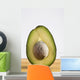Close Up Of An Avocado Standing Upright Cut In Half With The Pit Wall Mural