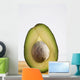 Close Up Of An Avocado Standing Upright Cut In Half With The Pit Wall Mural