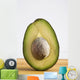 Close Up Of An Avocado Standing Upright Cut In Half With The Pit Wall Mural