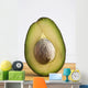 Close Up Of An Avocado Standing Upright Cut In Half With The Pit Wall Mural