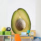 Close Up Of An Avocado Standing Upright Cut In Half With The Pit Wall Mural