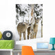 Two Young Deer In A Snow Covered Forest Chewing On Tree Bark Wall Mural