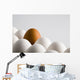 Close Up Of One Brown Shelled Egg Amongst Several White Shelled Eggs Wall Mural