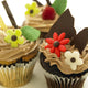 Close-Up Of Three Chocolate Cupcakes With Candy Flowers Wall Mural
