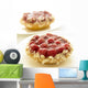 Close-Up Of Two Raspberry Tarts On White Plates Wall Mural