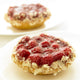 Close-Up Of Two Raspberry Tarts On White Plates Wall Mural