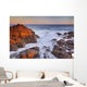 California, Malibu, Sunset over rocky ocean coastline Wall Mural