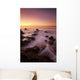 California, Malibu, Sunset over rocky ocean coastline Wall Mural