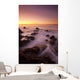California, Malibu, Sunset over rocky ocean coastline Wall Mural
