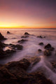 California, Malibu, Sunset over rocky ocean coastline Wall Mural