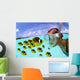 Over/under woman snorkeler face to face with Butterflyfish school Wall Mural