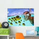 Over/under woman snorkeler face to face with Butterflyfish school Wall Mural