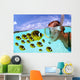 Over/under woman snorkeler face to face with Butterflyfish school Wall Mural