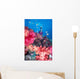 Diver in background of colorful soft coral reef scene with anthias Wall Mural