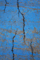 Close Up Of Cracks On A Blue Painted Asphalt Surface Wall Mural