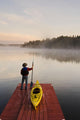 Man Standing By Kayak On Dock In Northwestern Ontario Wall Mural