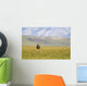 A Solitary Musk Ox Wanders Through The Grass Wall Mural