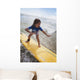 A young girl on a yellow surfboard;Gold coast queensland australia Wall Mural