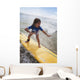 A young girl on a yellow surfboard;Gold coast queensland australia Wall Mural