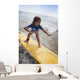 A young girl on a yellow surfboard;Gold coast queensland australia Wall Mural