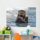 A Sea Otter Swimming Amongst Sea Ice In Harriman Fjord Wall Mural