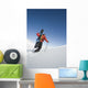 Man Backcountry Snowshoeing While Carrying A Snowboard Wall Mural