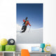 Man Backcountry Snowshoeing While Carrying A Snowboard Wall Mural