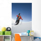 Man Backcountry Snowshoeing While Carrying A Snowboard Wall Mural