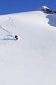Backcountry Snowboarder Carving Turns Down A Steep Mountain Face Wall Mural