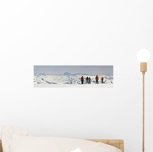 A Snowboarder And Skiers Hike Wall Mural