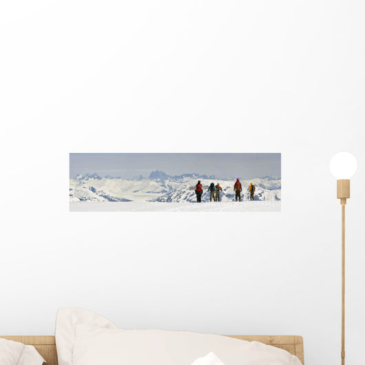 A Snowboarder And Skiers Hike Wall Mural