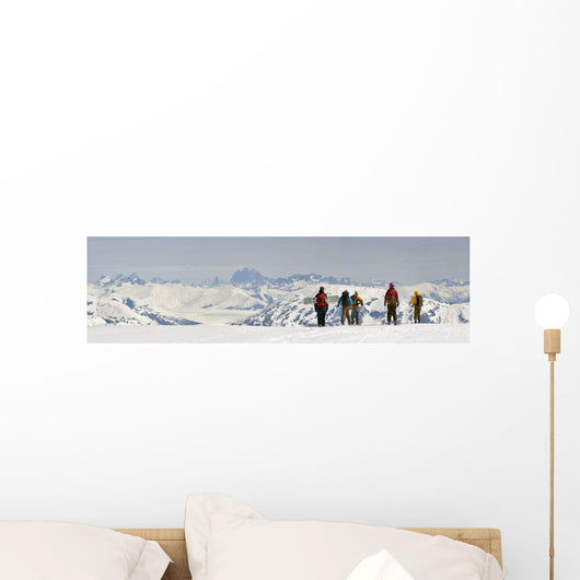A Snowboarder And Skiers Hike Wall Mural