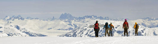 A Snowboarder And Skiers Hike Wall Mural