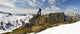 A Snowboarder Takes A Moment To Enjoy The View While Heliskiing Wall Mural