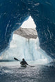 Sea Kayaker Paddles Through An Ice Cave Amongst Giant Icebergs Wall Mural