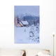 Snowcovered Home In A Wintry Meadow At Dawn With Inside Lights On Wall Mural