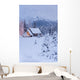 Snowcovered Home In A Wintry Meadow At Dawn With Inside Lights On Wall Mural