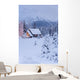 Snowcovered Home In A Wintry Meadow At Dawn With Inside Lights On Wall Mural