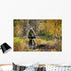 Man Mountain Biking With Dog Running Beside Him Wall Mural