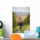 Man Mountain Biking With Dog Running Beside Him Wall Mural