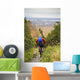 Man Mountain Biking With Dog Running Beside Him Wall Mural